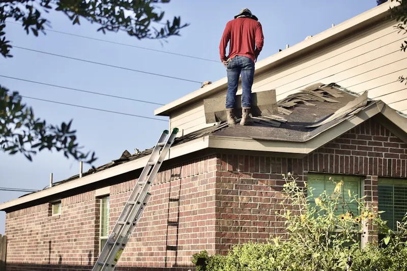 Professional roofer working on a residential roof in New Bloomington